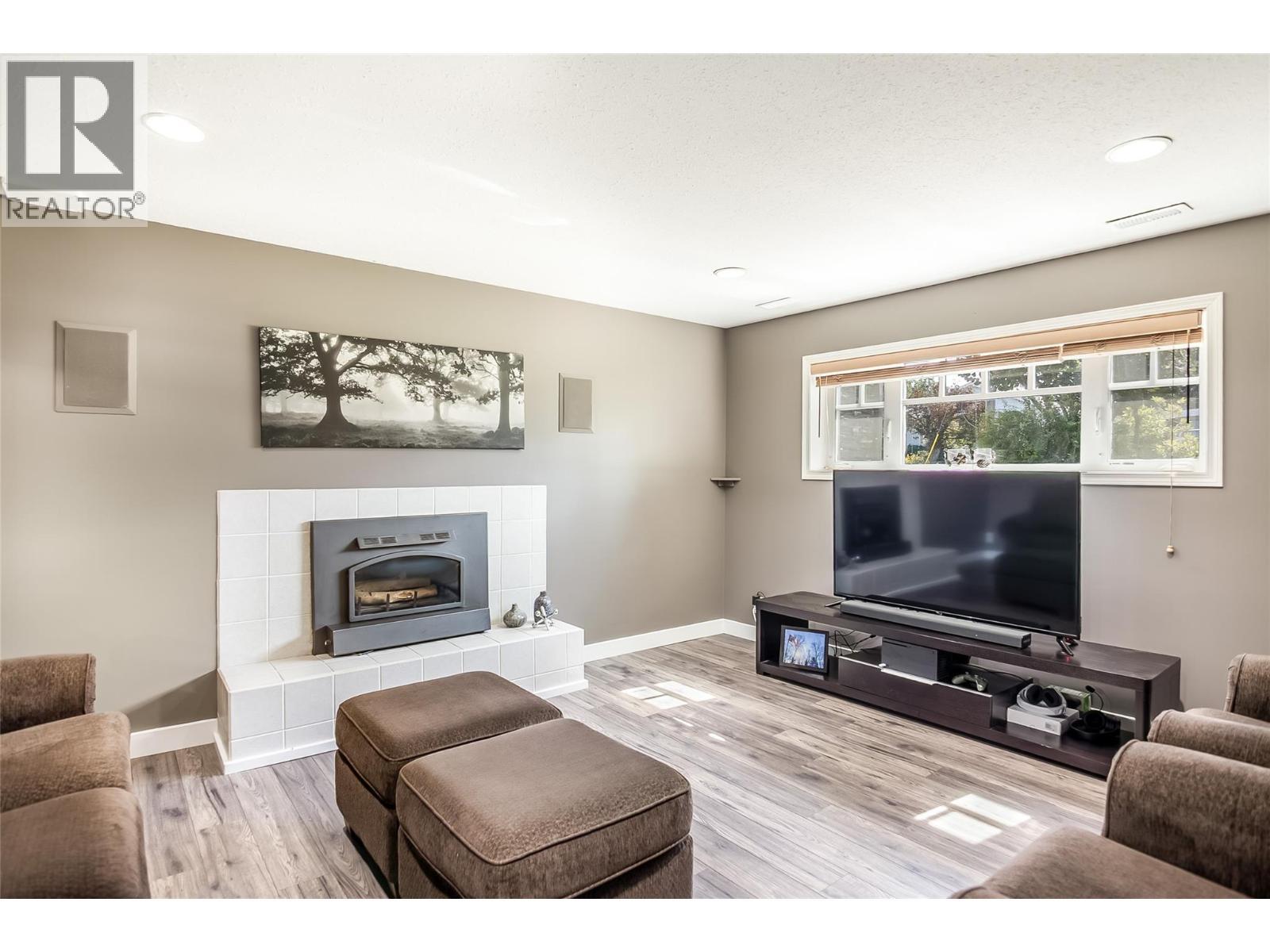TV Room Lower level - 1824 Colbeck Road, Revelstoke, BC - Indoor Photo Showing Living Room With Fireplace