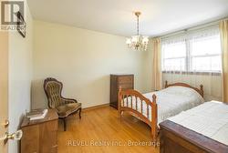 Primary bedroom with hardwood floors -