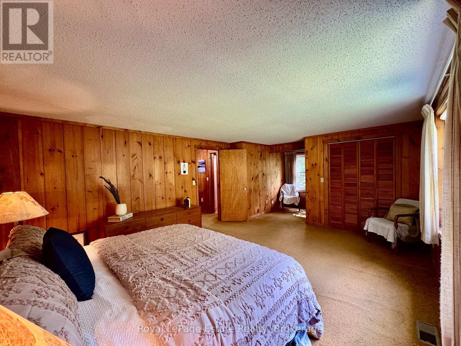 The primary has a large closet & cozy nook - 44 Whitefish Boulevard, South Bruce Peninsula, ON - Indoor Photo Showing Bedroom