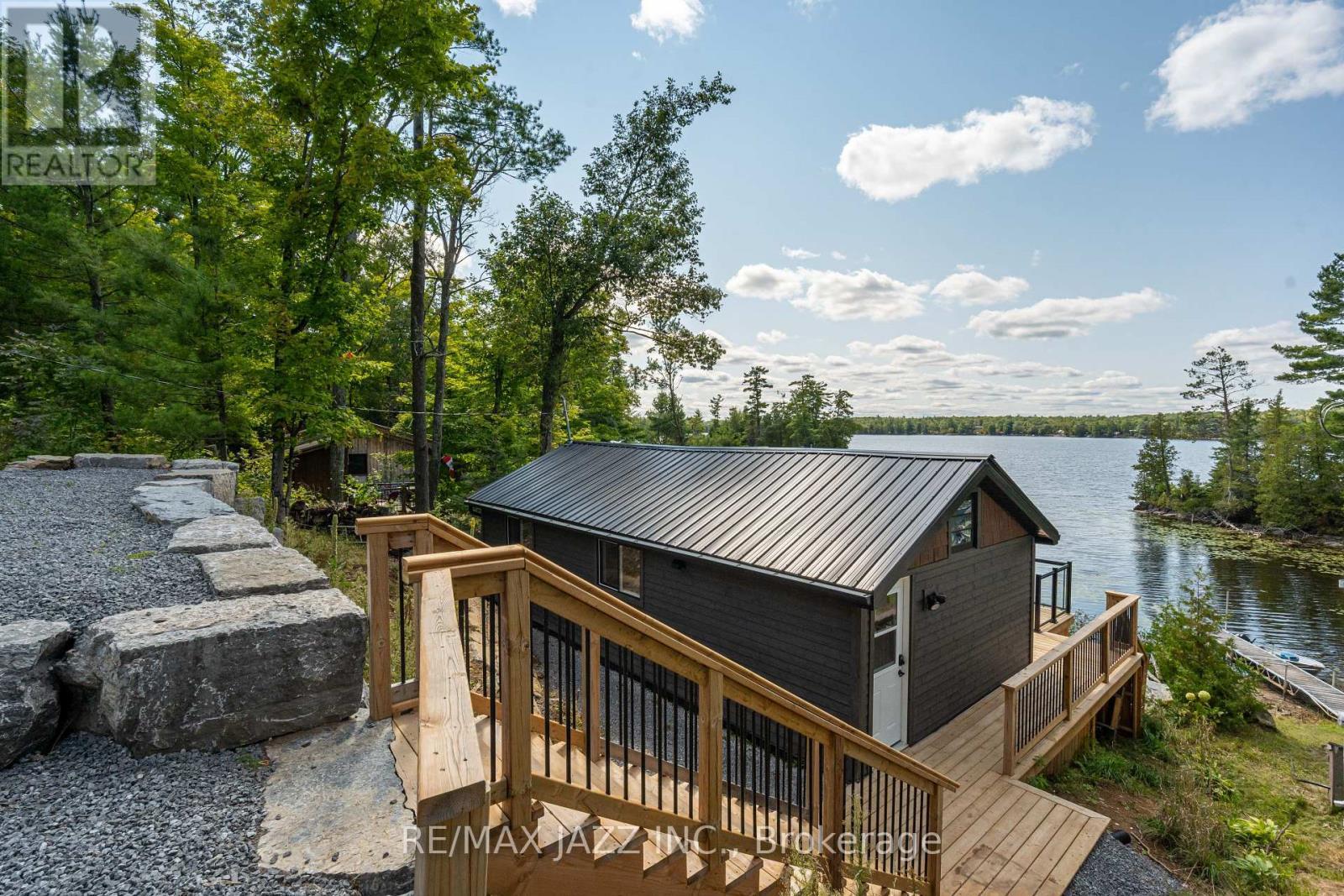 New wood siding and metal roof. - 348 Fire Rte 54, Havelock-Belmont-Methuen (Belmont-Methuen), ON - Outdoor With Body Of Water
