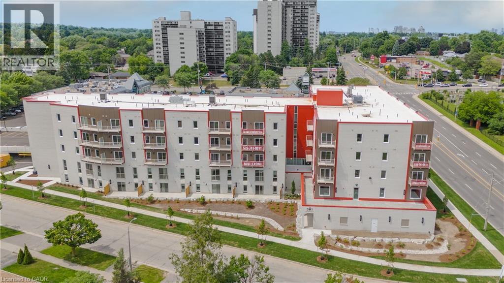 View of urban area featuring apartment complex / building - 301 Westmount Road W Unit# 205, Kitchener, ON - Outdoor With Balcony With Facade