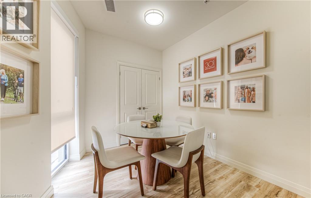 Dining area with wood finished floors and baseboards - 301 Westmount Road W Unit# 205, Kitchener, ON - Indoor Photo Showing Dining Room