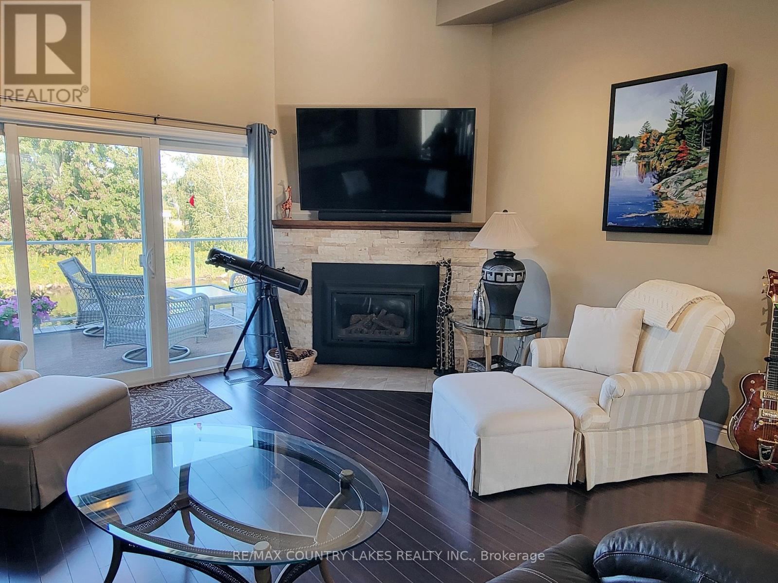 11 - 4 Paradise Boulevard, Ramara, ON - Indoor Photo Showing Living Room With Fireplace