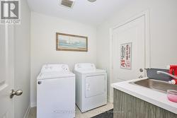 Main floor laundry room with stainless steel sink -