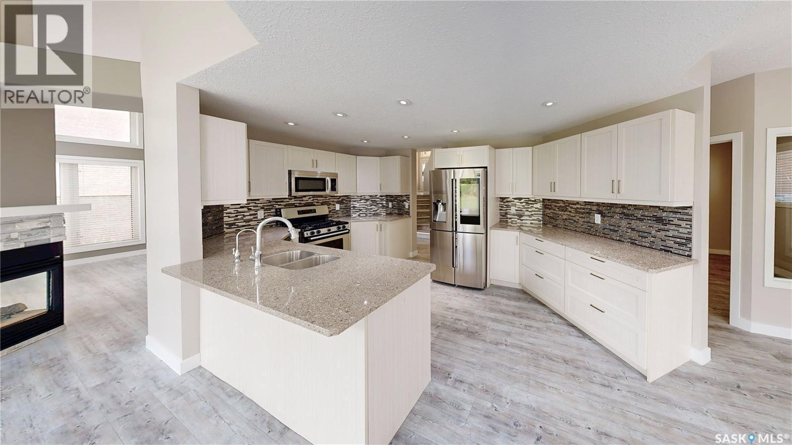5006 Wascana Vista Court, Regina, SK - Indoor Photo Showing Kitchen With Fireplace With Stainless Steel Kitchen With Double Sink With Upgraded Kitchen