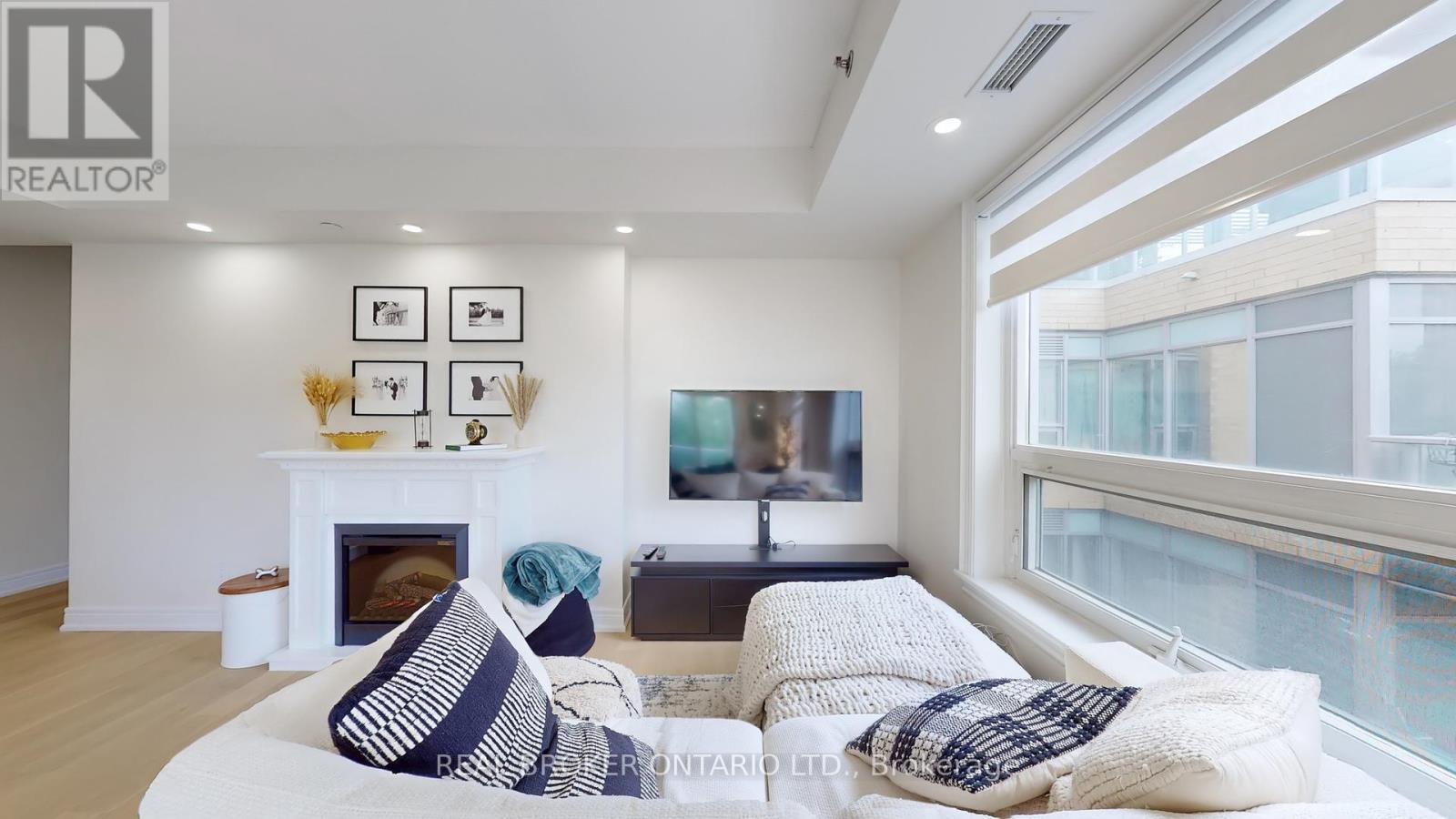 415 - 701 Sheppard Avenue W, Toronto, ON - Indoor Photo Showing Living Room With Fireplace