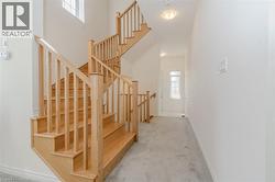 Staircase featuring carpet floors and a towering ceiling -