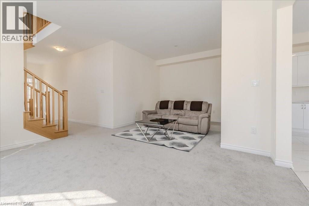 Living room featuring light colored carpet and stairway - 35 Hitchman Street, Paris, ON - Indoor Photo Showing Other Room