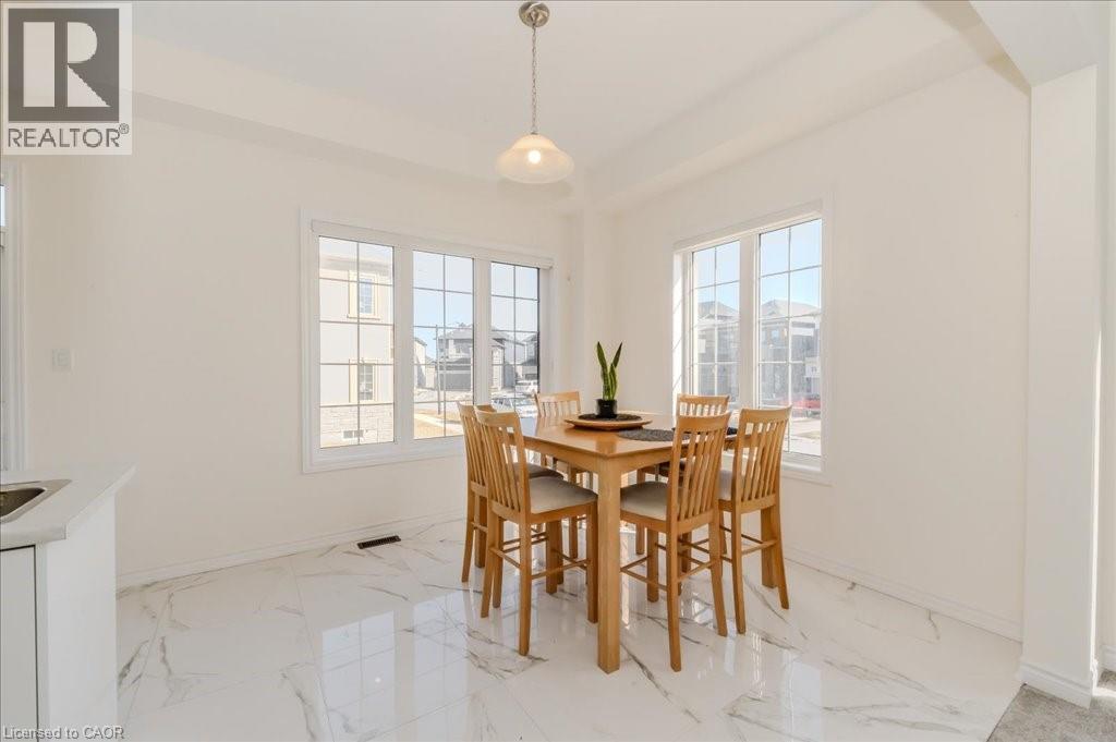 Dining room with plenty of natural light and light marble finish floors - 35 Hitchman Street, Paris, ON - Indoor Photo Showing Dining Room