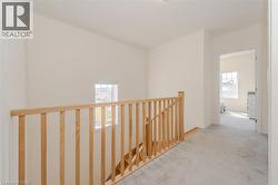 Corridor featuring carpet and an upstairs landing -
