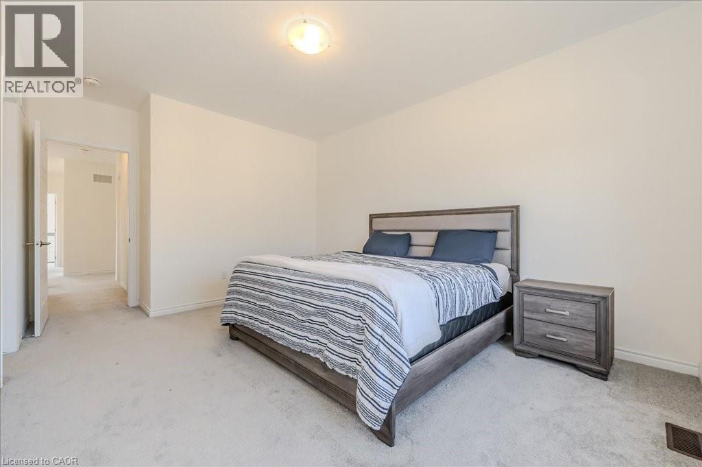Bedroom with light colored carpet and baseboards - 35 Hitchman Street, Paris, ON - Indoor Photo Showing Bedroom