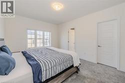 Bedroom with carpet and baseboards -