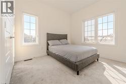 Carpeted bedroom with baseboards -