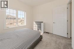 Bedroom featuring carpet flooring and baseboards -