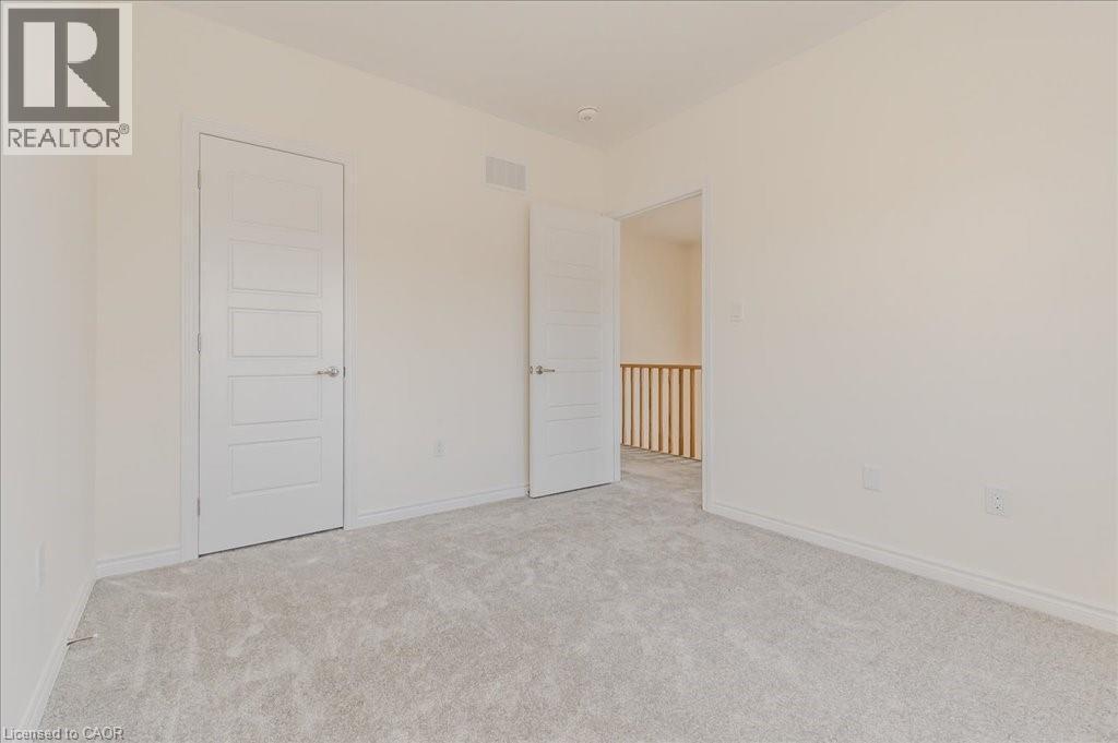 Unfurnished bedroom featuring light colored carpet and baseboards - 35 Hitchman Street, Paris, ON - Indoor Photo Showing Other Room