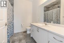 Bathroom featuring vanity and curtained shower -