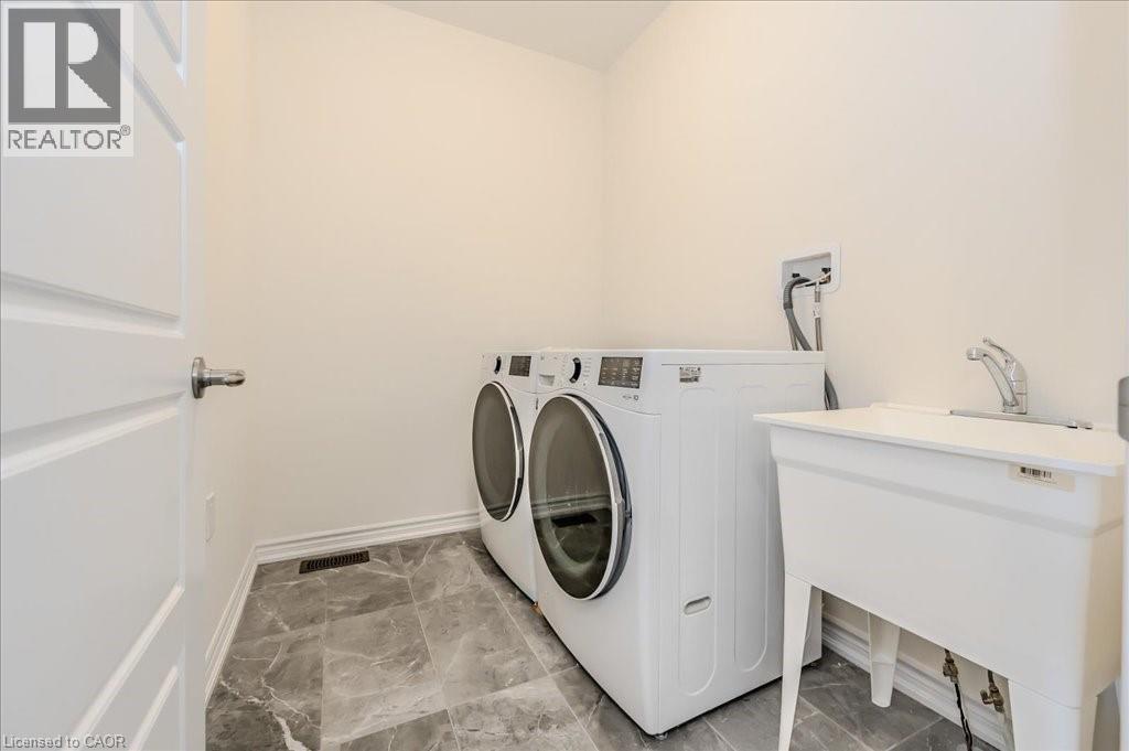 Washroom with baseboards and independent washer and dryer - 35 Hitchman Street, Paris, ON - Indoor Photo Showing Laundry Room