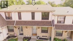 Back of house featuring roof with shingles and board and batten siding -