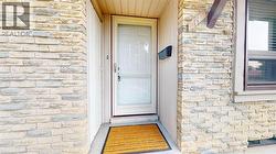 View of exterior entry with stone siding -