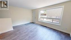 Spare room with baseboards and wood finished floors -