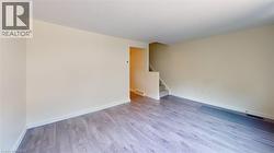 Empty room featuring light wood-type flooring and stairway -