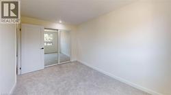 Unfurnished bedroom with light colored carpet, a closet, and recessed lighting -
