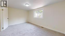 Spare room with light carpet and baseboards -