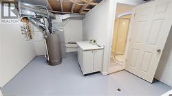 Unfinished below grade area with gas water heater and heating unit -