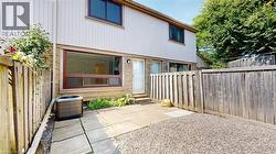 Rear view of property with a fenced backyard, a patio area, and entry steps -