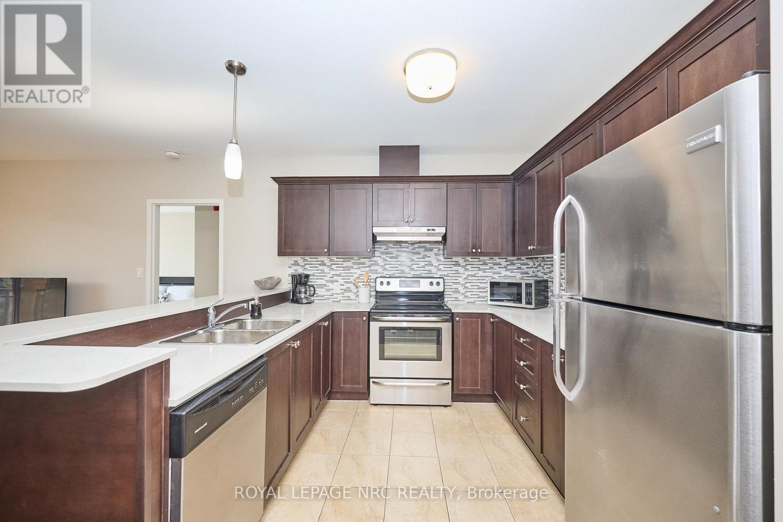 Quartz counters, stainless steel appliances. - 304 - 26 Wellington Street, St. Catharines (Downtown), ON - Indoor Photo Showing Kitchen With Stainless Steel Kitchen With Double Sink With Upgraded Kitchen