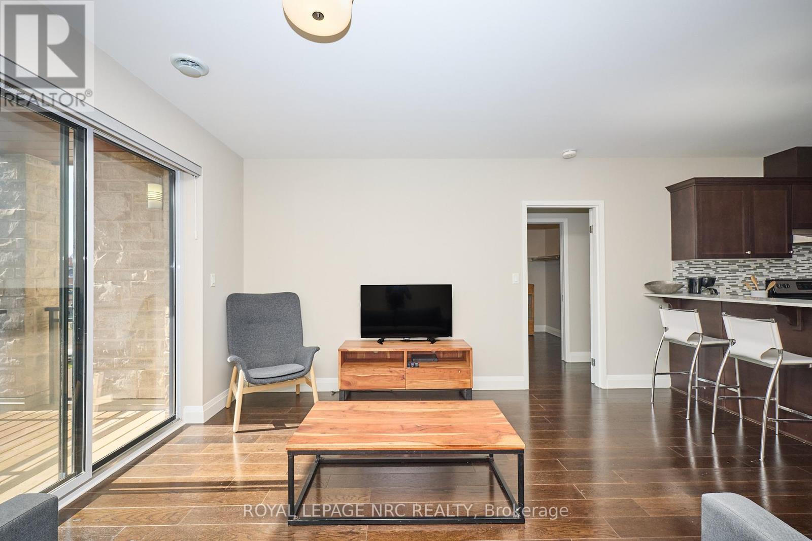 Access to open, private, glass panel balcony. - 304 - 26 Wellington Street, St. Catharines (Downtown), ON - Indoor Photo Showing Living Room