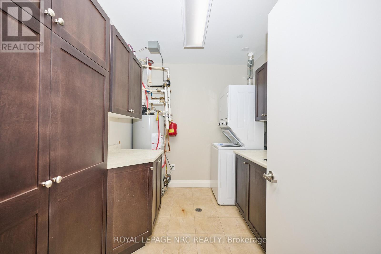 In-suite laundry w/pantry and ample storage. - 304 - 26 Wellington Street, St. Catharines (Downtown), ON - Indoor Photo Showing Laundry Room