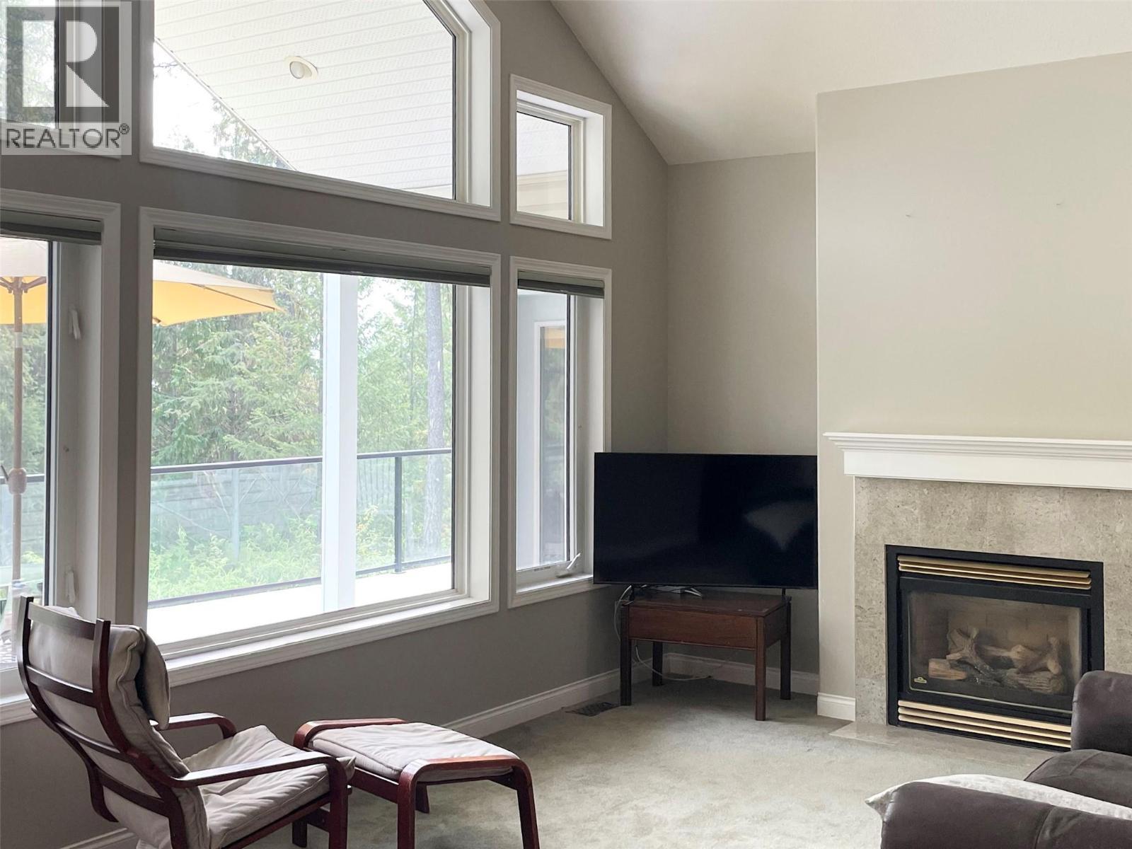 253 Chase Road, Christina Lake, BC - Indoor Photo Showing Living Room With Fireplace