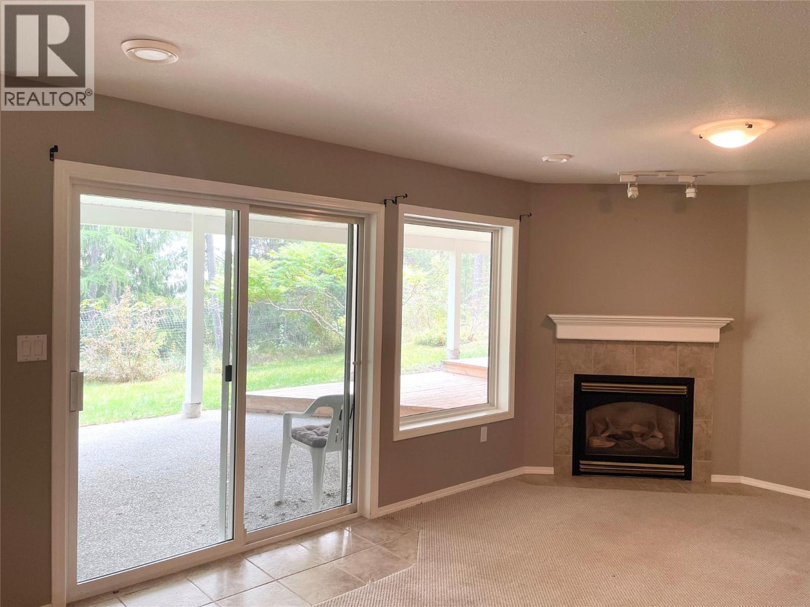 253 Chase Road, Christina Lake, BC - Indoor Photo Showing Other Room With Fireplace