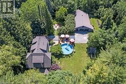 Aerial view of house, fire pit and detached garage -