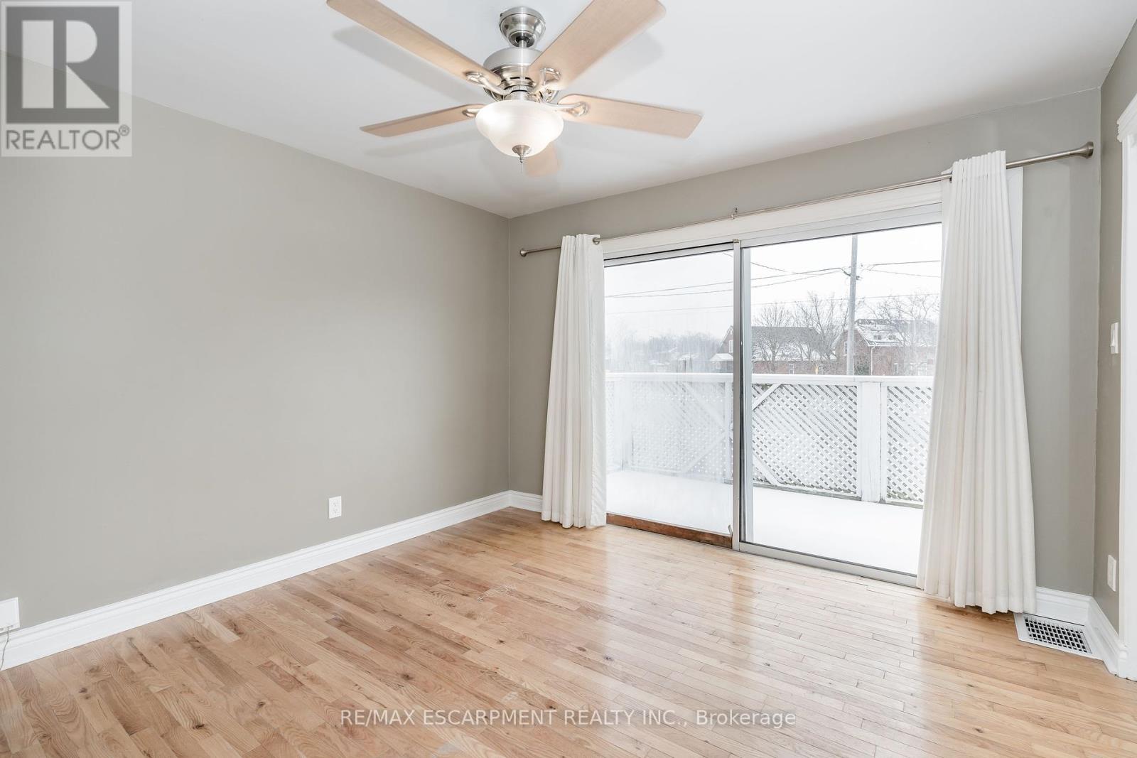 Walk out to a private deck. - (Upper) - 317 King Street E, Hamilton, ON - Indoor Photo Showing Other Room