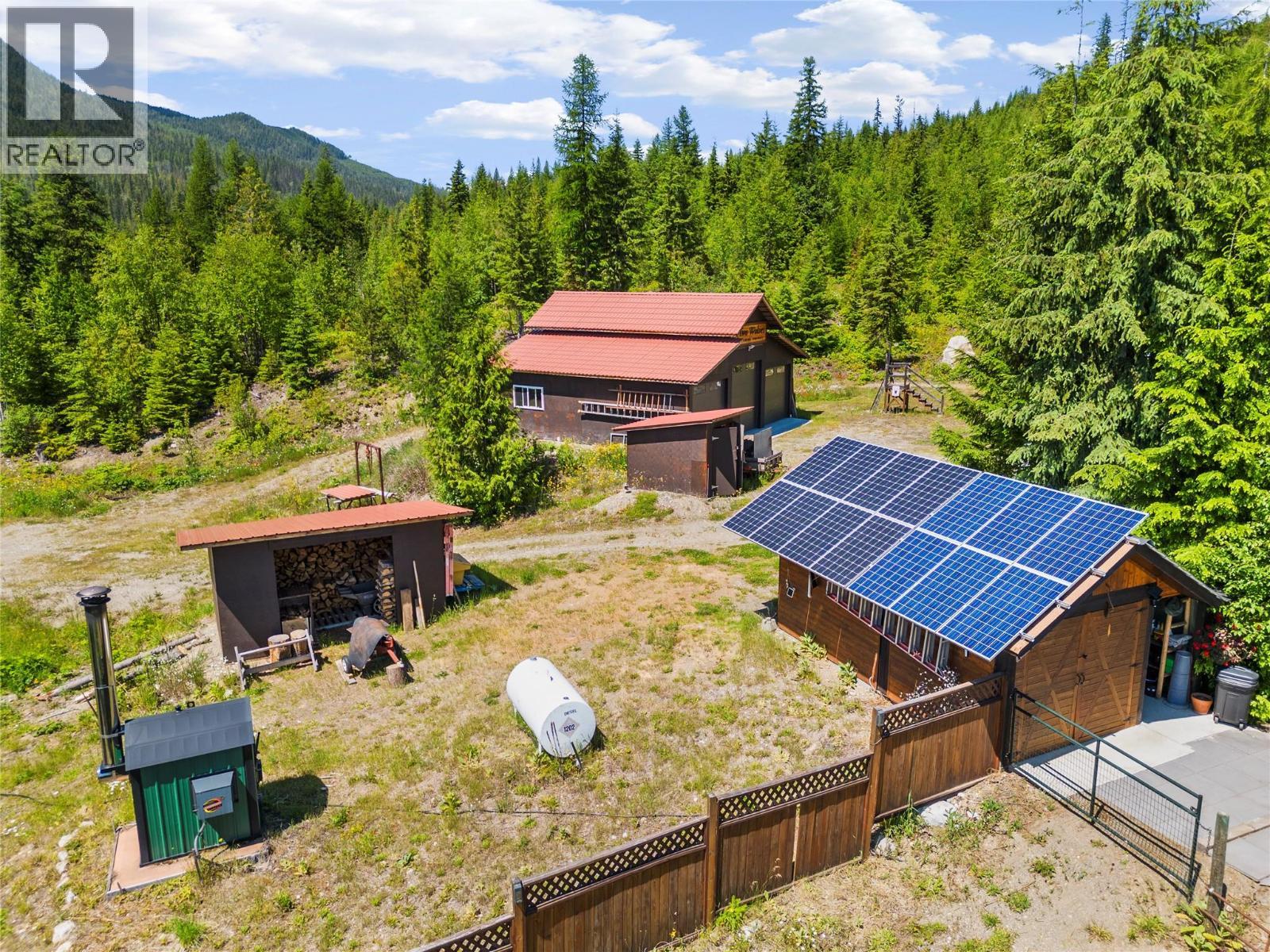 Battery Shed (solar). Wood shed holds 6 cords. - 1309 Eagle Ridge Road, Lumby, BC - Outdoor With Deck Patio Veranda
