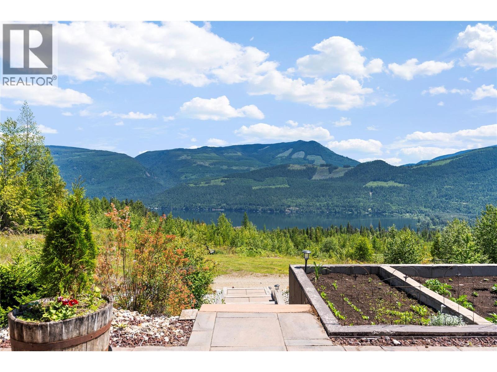Pathway around the gardens - 1309 Eagle Ridge Road, Lumby, BC - Outdoor With Body Of Water With View