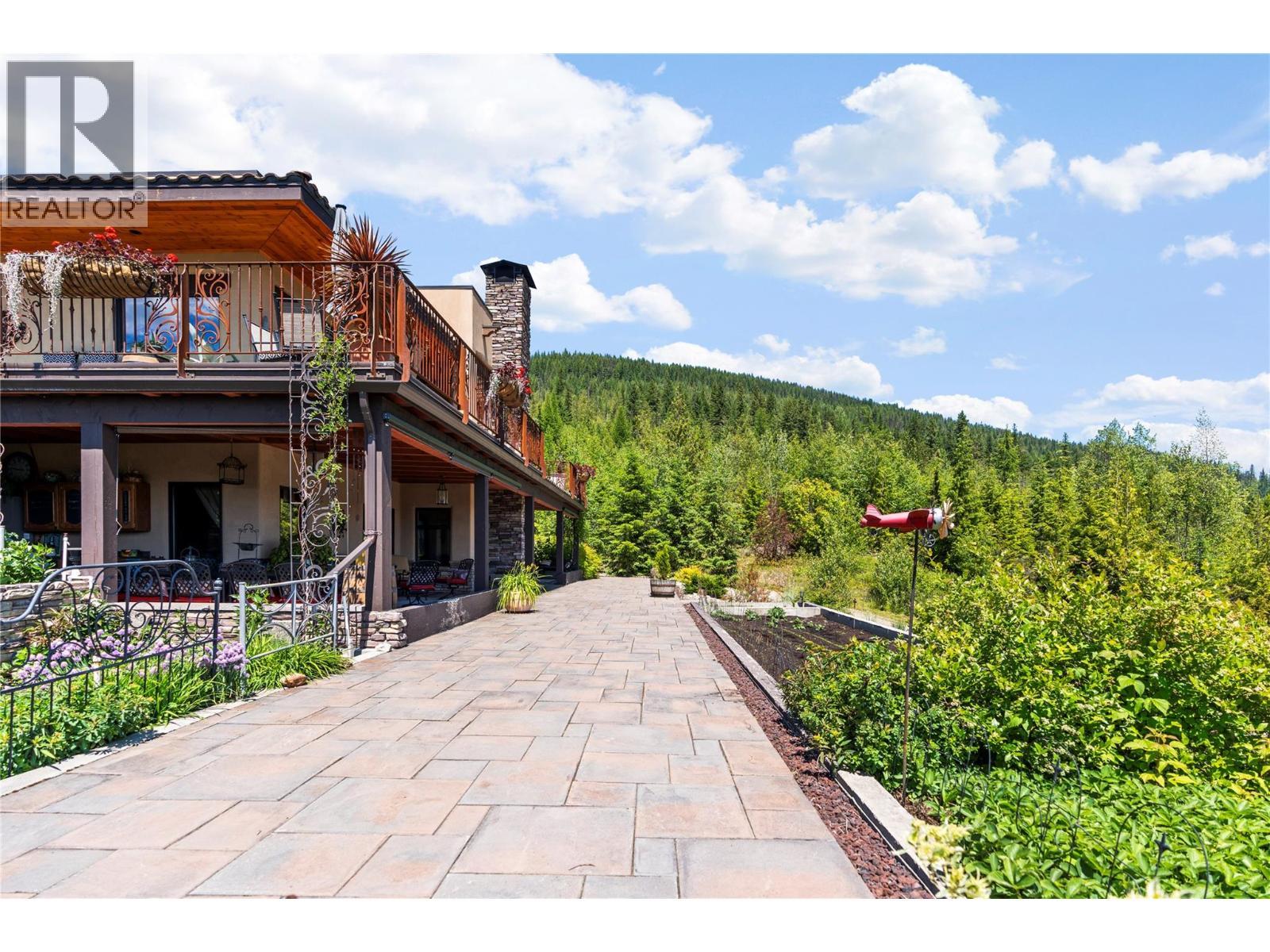 Pathway along the side of the home - 1309 Eagle Ridge Road, Lumby, BC - Outdoor With Deck Patio Veranda
