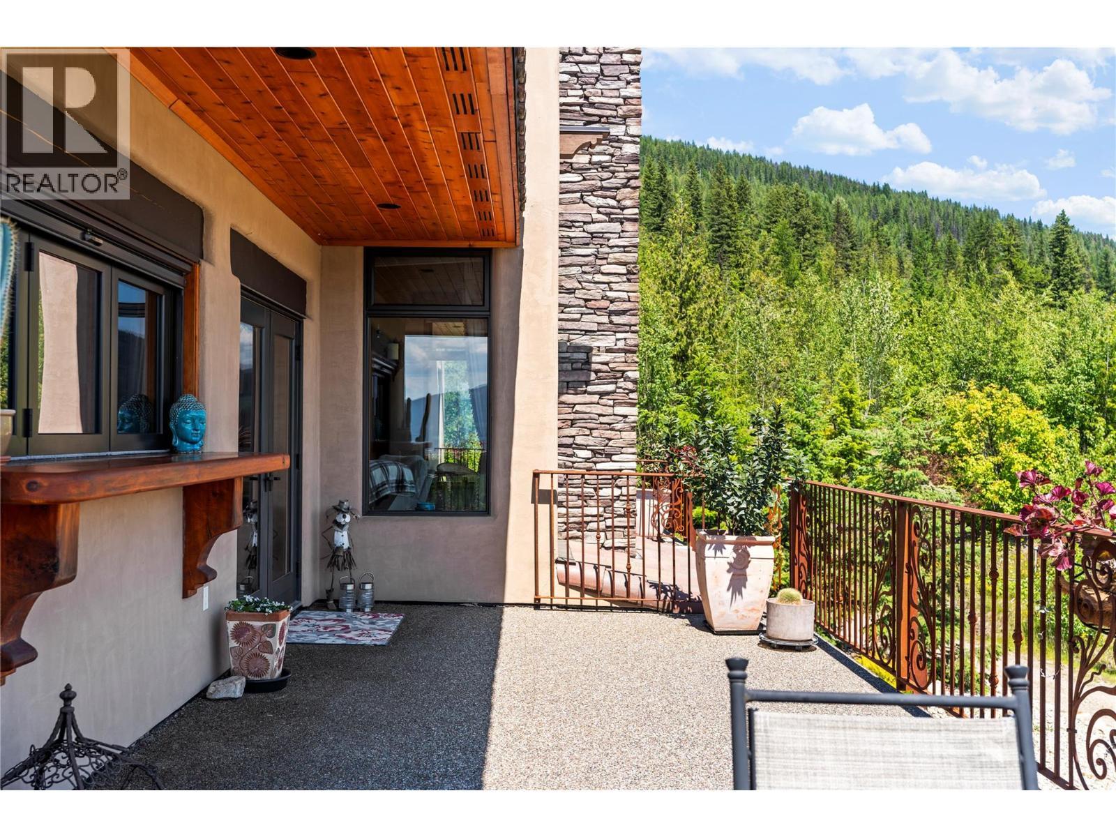 Upper level wrap around deck & patio door - 1309 Eagle Ridge Road, Lumby, BC - Outdoor With Deck Patio Veranda