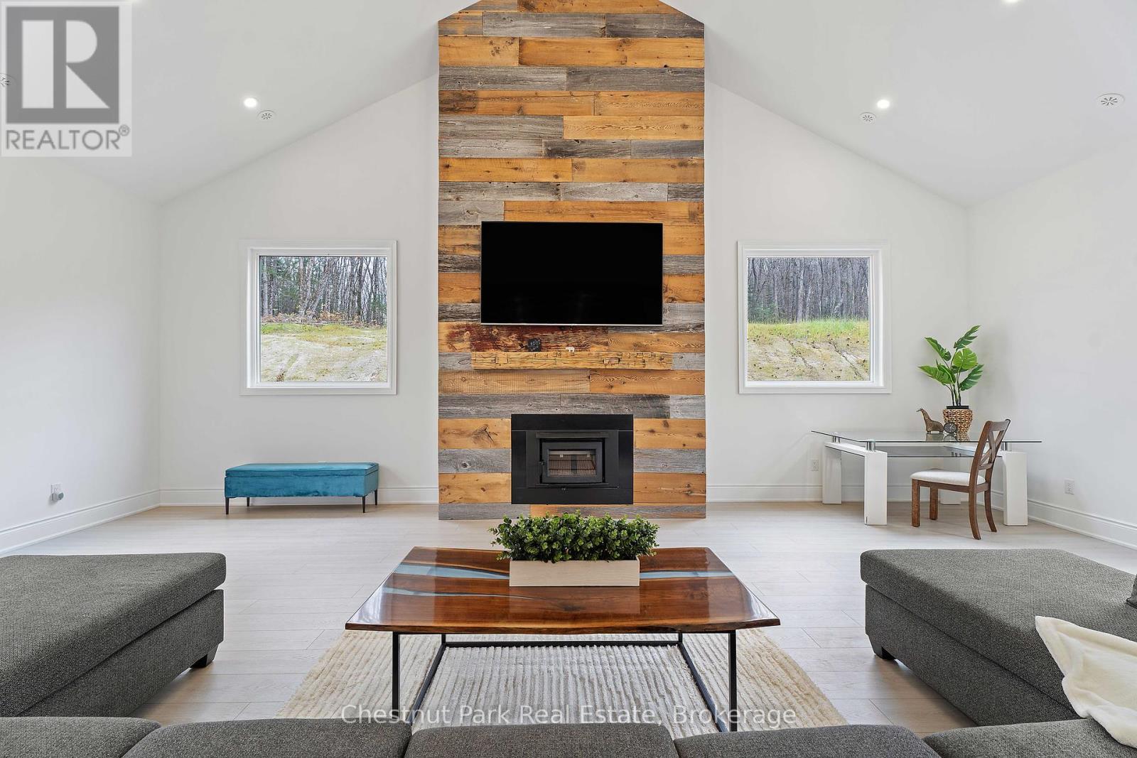 1153 Deer Lake Road, Perry (Emsdale), ON - Indoor Photo Showing Living Room With Fireplace