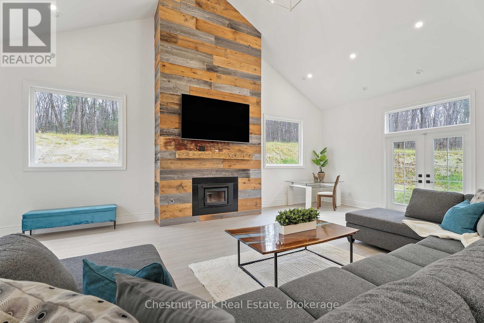 1153 Deer Lake Road, Perry (Emsdale), ON - Indoor Photo Showing Living Room With Fireplace
