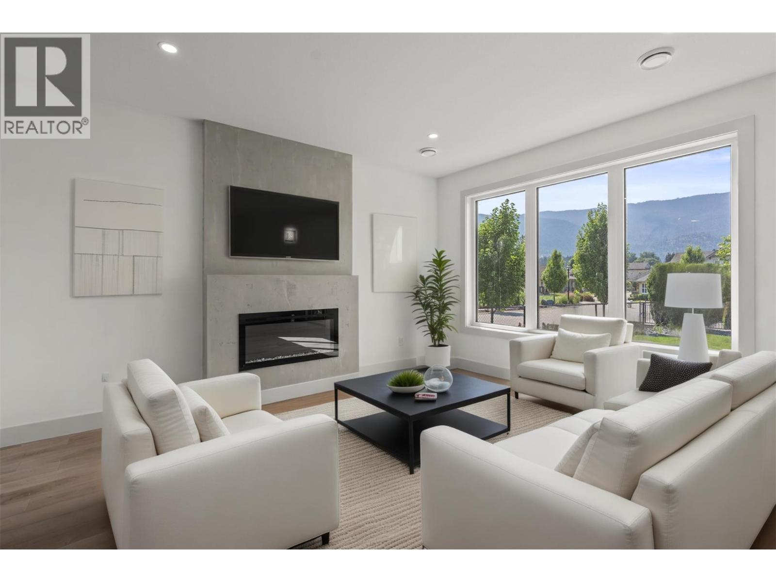 Living room is virtually staged - 2345 Patterson Avenue Unit# 101, Armstrong, BC - Indoor Photo Showing Living Room With Fireplace