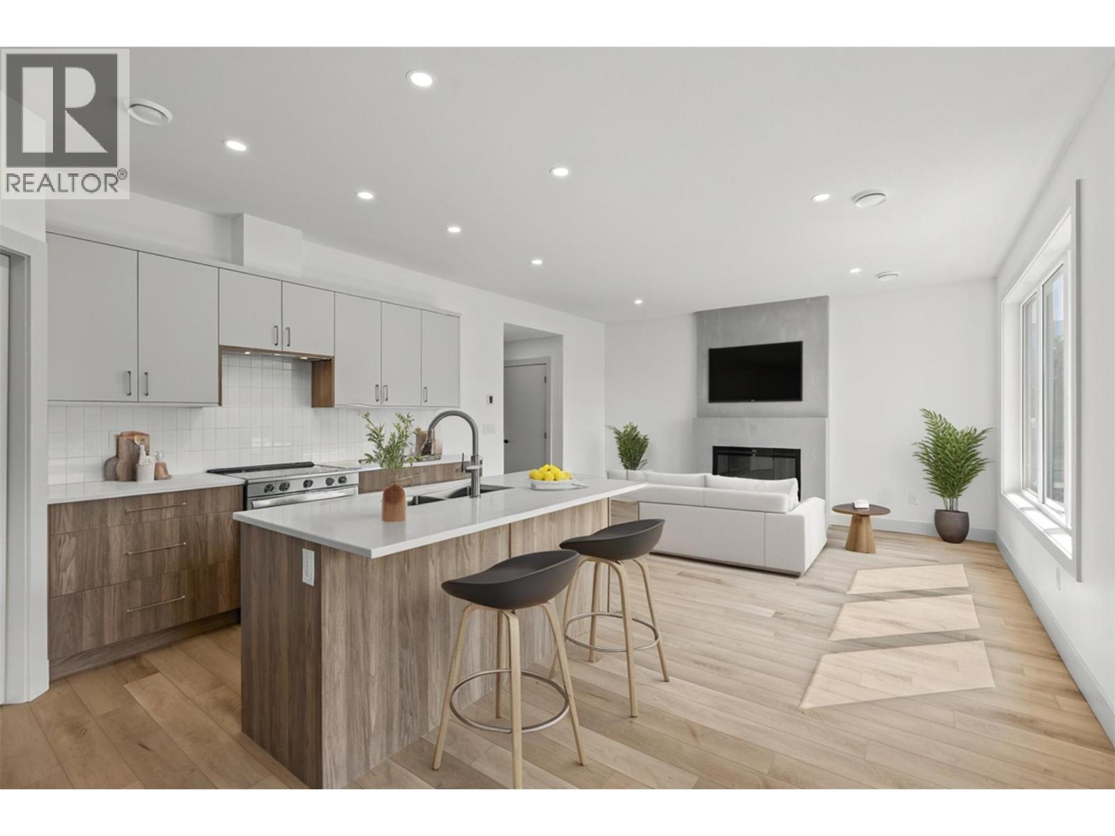 Living room & kitchen virtually staged - 2345 Patterson Avenue Unit# 101, Armstrong, BC - Indoor Photo Showing Kitchen With Upgraded Kitchen