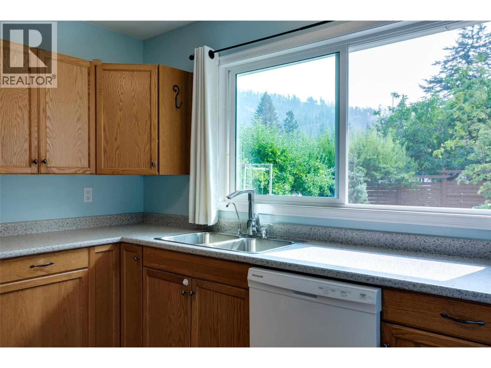 1257 And 1259 Rio Drive, Kelowna, BC - Indoor Photo Showing Kitchen With Double Sink