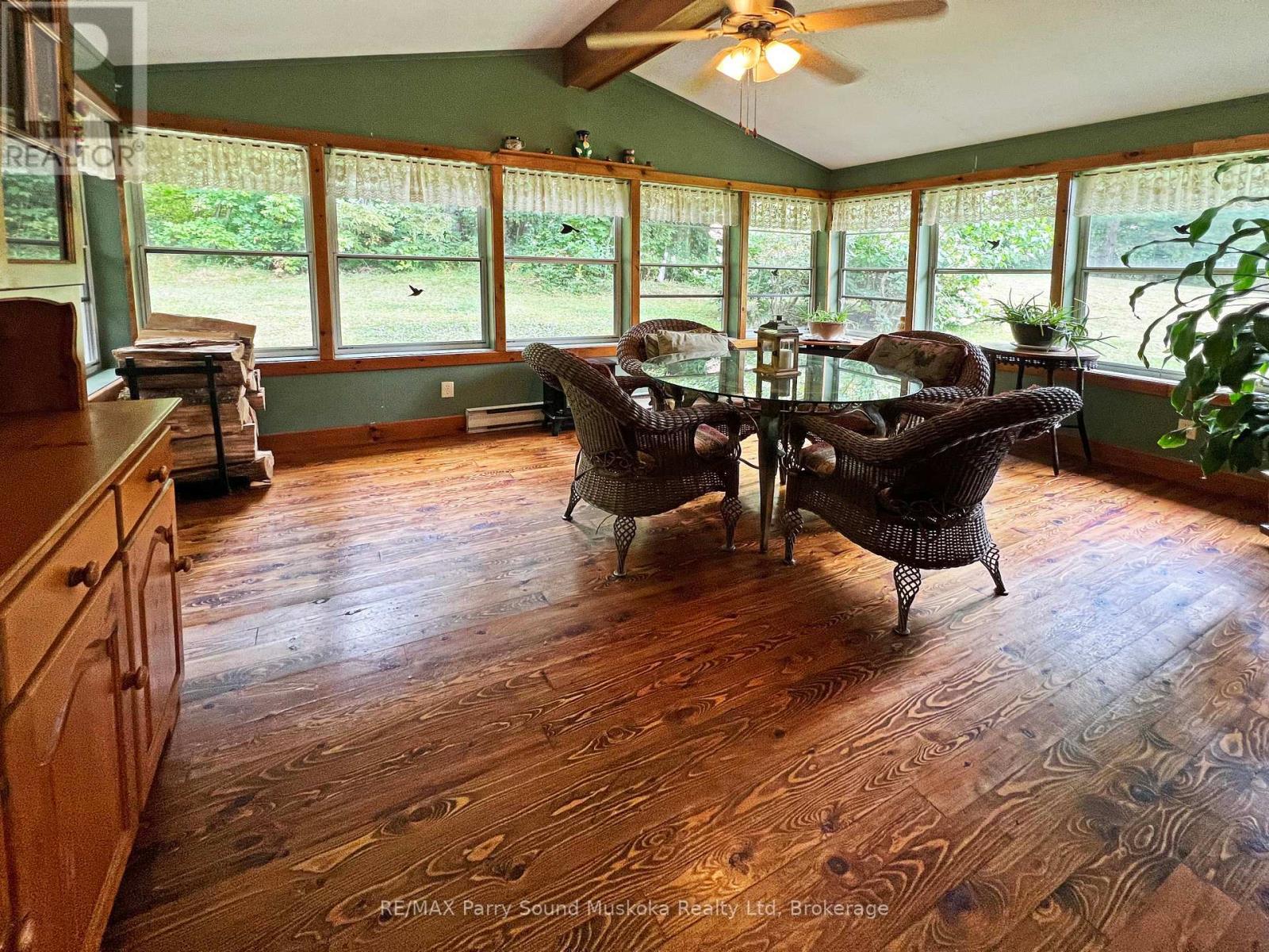 Fabulous 3 season sunroom wrapped in windows - 159 Boundary Spur Road, Whitestone (Dunchurch), ON - Indoor Photo Showing Dining Room