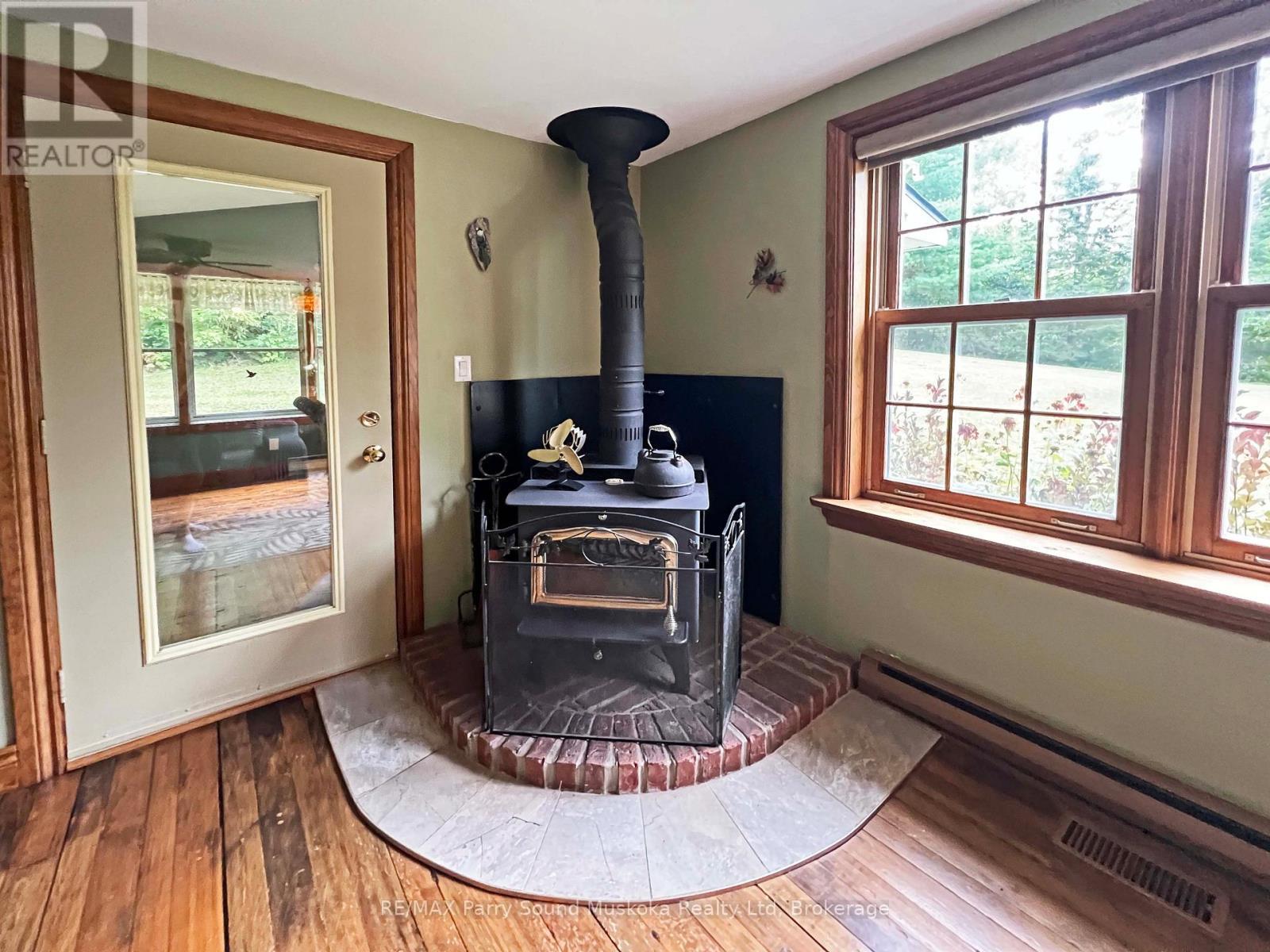 Cozy airtight woodstove - 159 Boundary Spur Road, Whitestone (Dunchurch), ON - Indoor Photo Showing Other Room