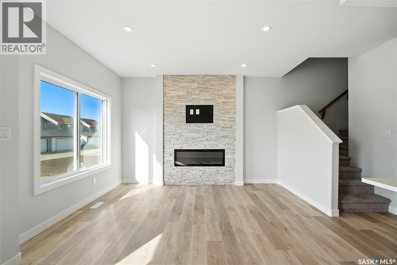 512 Myles Heidt Manor, Saskatoon, SK - Indoor Photo Showing Living Room With Fireplace