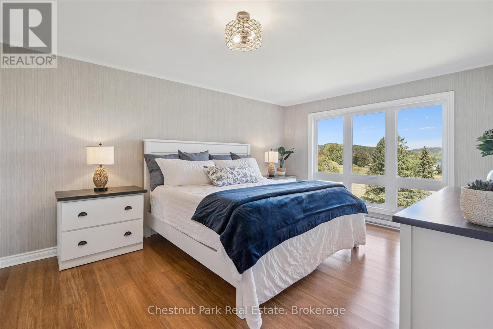 Primary Bedroom with beautiful lake views - 31-303 - 1235 Deerhurst Drive, Huntsville (Chaffey), ON - Indoor Photo Showing Bedroom