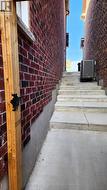 Concrete side stairs leading to the backyard -